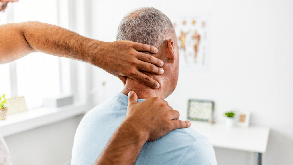 Physical therapist massaging patient's neck to relief neck pain